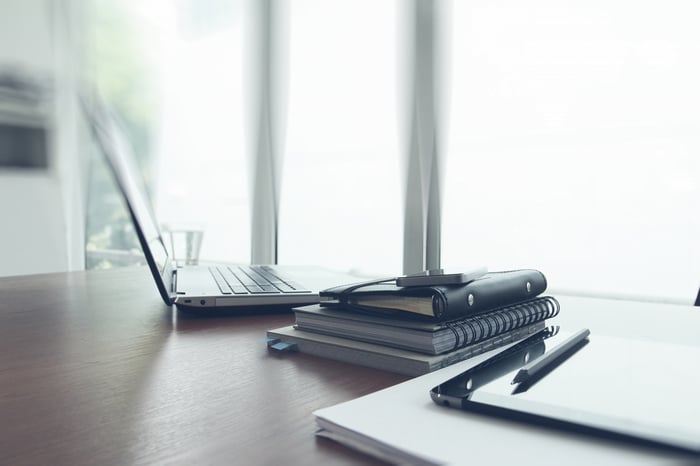 Office workplace with laptop and smart phone on wood table-1