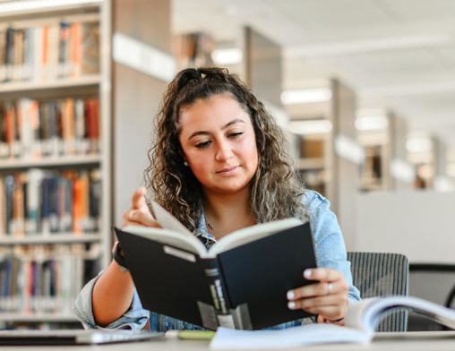 NU Student Reading a Book