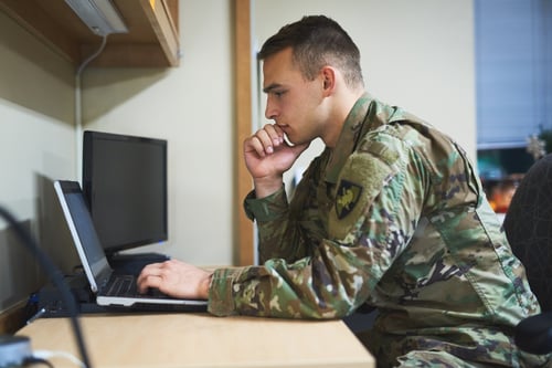 Military man working on a computer