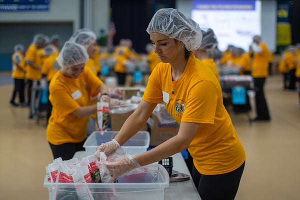 day-of-service-neumann-student-packing-meals